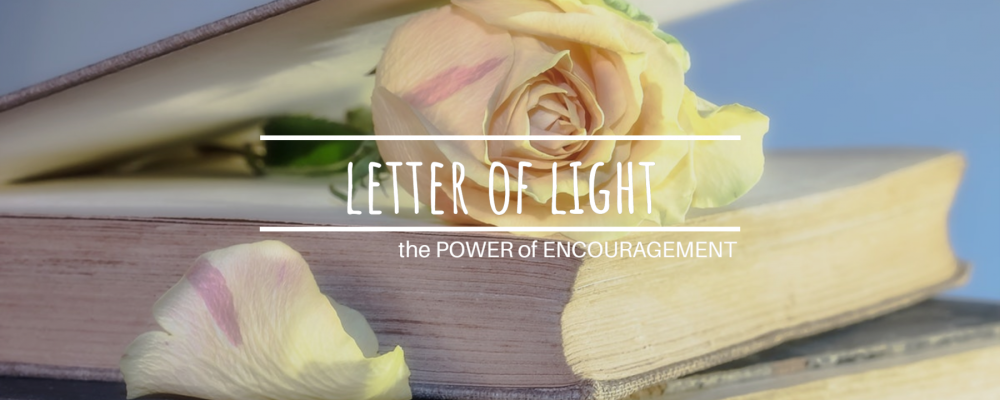 Letter of Light: The Power of Encouragement. Stacked old books and a romantic yellow and pink rose.
